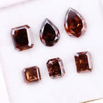 Set of premium brown lab-grown diamonds in emerald, pear, and octagon cuts displaying rich fancy color and brilliant faceting for custom fine jewelry designs.