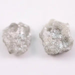 Natural rough gray diamond pair featuring raw, uncut beauty.