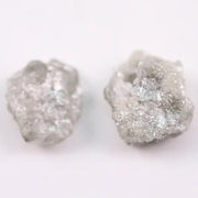 Natural rough gray diamond pair featuring raw, uncut beauty.