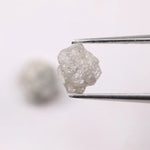 Natural rough gray diamond pair featuring raw, uncut beauty.