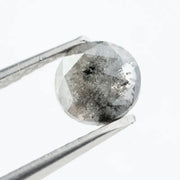Round brilliant cut lab-grown salt and pepper diamond with unique gray and black inclusions, perfect for custom rings and fine jewelry.