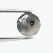 Round brilliant cut lab-grown salt and pepper diamond with unique gray and black inclusions, perfect for custom rings and fine jewelry.
