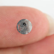 Round brilliant cut lab-grown salt and pepper diamond with unique gray and black inclusions, perfect for custom rings and fine jewelry.