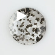 Close-up of a unique lab-grown diamond featuring distinct black carbon inclusions, showcasing its natural beauty and sustainable origins.