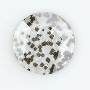 Close-up of a unique lab-grown diamond featuring distinct black carbon inclusions, showcasing its natural beauty and sustainable origins.