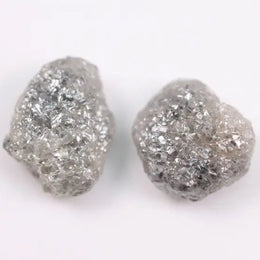 Raw gray diamond pair showing salt and pepper inclusions