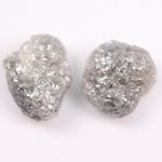 Raw gray diamond pair showing salt and pepper inclusions