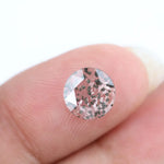Close-up of a unique lab-grown diamond featuring distinct black carbon inclusions, showcasing its natural beauty and sustainable origins.