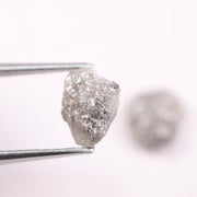 Raw gray diamond pair showing salt and pepper inclusions