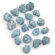 blue natural raw diamond pieces arranged as a loose uncut rough diamond lot
