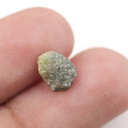 uncut yellow natural diamond with a rugged, irregular surface for designing personalized gold jewelry pieces.