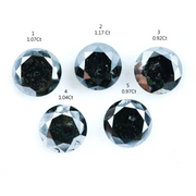Five natural round cut black diamonds with faceted surfaces showing natural inclusions and dark carbon tones, loose untreated genuine diamonds suitable for custom jewelry making.