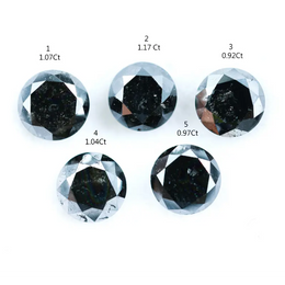 Five natural round cut black diamonds with faceted surfaces showing natural inclusions and dark carbon tones, loose untreated genuine diamonds suitable for custom jewelry making.