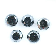 Five natural round cut black diamonds with faceted surfaces showing natural inclusions and dark carbon tones, loose untreated genuine diamonds suitable for custom jewelry making.