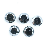 Five natural round cut black diamonds with faceted surfaces showing natural inclusions and dark carbon tones, loose untreated genuine diamonds suitable for custom jewelry making.