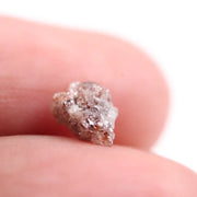a raw diamond showing cost of raw diamond and how to identify a raw diamond at home with loose raw diamonds and a natural raw diamond ring display