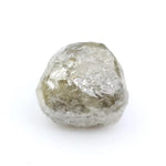 Raw diamond crystal inspected under bright lighting.