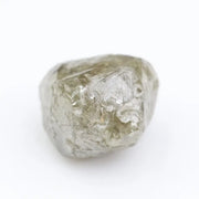 Raw diamond crystal inspected under bright lighting.