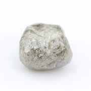 Raw diamond crystal inspected under bright lighting.