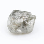 Large raw gemstones and rough diamond crystals displayed together.