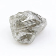Large raw gemstones and rough diamond crystals displayed together.