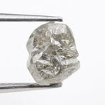 Large raw gemstones and rough diamond crystals displayed together.