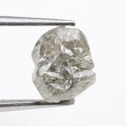 Large raw gemstones and rough diamond crystals displayed together.
