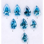Eight vivid blue pear cut lab grown diamonds displayed on white background, featuring brilliant faceting, teardrop shape, and rich ocean blue tones ideal for custom engagement rings and fine jewelry.