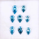 Eight vivid blue pear cut lab grown diamonds displayed on white background, featuring brilliant faceting, teardrop shape, and rich ocean blue tones ideal for custom engagement rings and fine jewelry.
