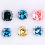 Six cushion cut lab grown diamonds in fancy colors including deep teal, vivid blue, pink, yellow, and light blue displayed on white background for fine jewelry design.