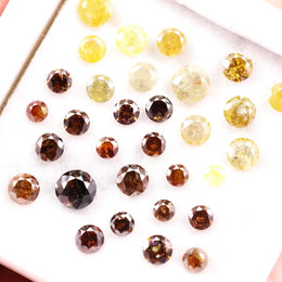 Assorted round brilliant cut natural diamonds in yellow and brown colors, loose fancy diamonds ideal for engagement rings, custom jewelry making, and diamond supply collection.