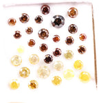 Assorted round brilliant cut natural diamonds in yellow and brown colors, loose fancy diamonds ideal for engagement rings, custom jewelry making, and diamond supply collection.