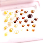Assorted round brilliant cut natural diamonds in yellow and brown colors, loose fancy diamonds ideal for engagement rings, custom jewelry making, and diamond supply collection.