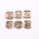 Six emerald cut lab grown diamonds with soft champagne color and visible internal growth pattern inclusions, arranged in two rows and numbered 1 through 6 on a white background.