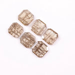 Six emerald cut lab grown diamonds with soft champagne color and visible internal growth pattern inclusions, arranged in two rows and numbered 1 through 6 on a white background.