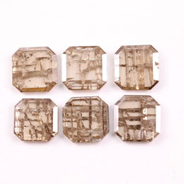 Six emerald cut lab grown diamonds with soft champagne color and visible internal growth pattern inclusions, arranged in two rows and numbered 1 through 6 on a white background.
