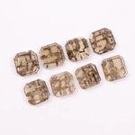 Emerald step cut lab grown diamonds with champagne tone and visible natural-style inclusions arranged in two rows on a white background.