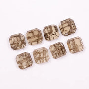 Emerald step cut lab grown diamonds with champagne tone and visible natural-style inclusions arranged in two rows on a white background.