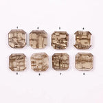 Emerald step cut lab grown diamonds with champagne tone and visible natural-style inclusions arranged in two rows on a white background.