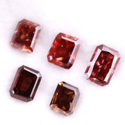 Five emerald cut lab grown fancy red pink diamonds displayed on white background, octagon step cut synthetic CVD diamonds in various deep red and blush tones for fine jewelry use.