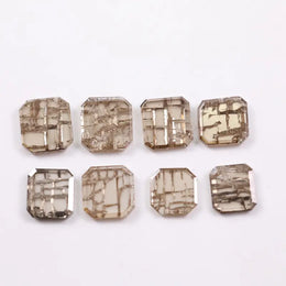 Square cut lab grown diamond with champagne tone and distinctive geometric grid-like inclusions, octagonal step cut, transparent stone for modern sustainable fine jewelry design.