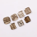 Emerald cut lab grown diamond featuring natural-inspired linear inclusions in a step cut octagonal shape, showcasing warm champagne tones and geometric internal patterns on a clean white background.