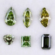 Six fancy color lab grown diamonds in green and yellow shades displayed on white background, featuring pear, marquise, heart, princess, and emerald cuts.