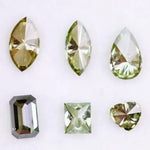 Six fancy color lab grown diamonds in green and yellow shades displayed on white background, featuring pear, marquise, heart, princess, and emerald cuts.