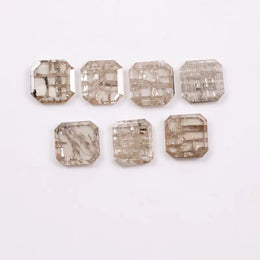 Emerald cut lab grown diamond with visible natural-style inclusions and salt and pepper pattern, octagon step cut sustainable gemstone for engagement ring or custom fine jewelry.