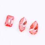 Three lab grown pink diamonds displayed on a white background, including a pear cut, marquise cut, and emerald cut fancy vivid pink loose diamonds for custom fine jewelry and engagement rings.