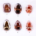 Six fancy colored lab grown diamonds in pink, peach, and cognac tones featuring emerald cut, oval cut, and pear cut shapes displayed on a white background, ethical CVD loose stones for custom fine jewelry.