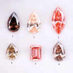 Six fancy colored lab grown diamonds including pear, marquise, and emerald cuts in pink, peach, champagne, and brown tones displayed on a white background, ideal for custom engagement rings and fine jewelry.