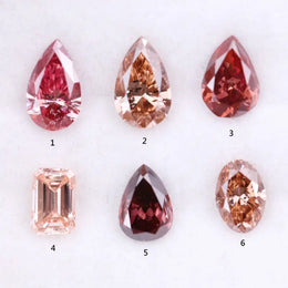 Six lab grown fancy colored diamonds in pink, blush, champagne and deep rose tones featuring pear, oval and emerald cuts displayed on a white background for fine jewelry design.
