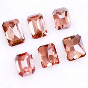 Six lab grown fancy orange pink emerald cut diamonds displayed on a white background, rectangular step cut loose grown diamonds in various reddish peach shades for engagement rings and fine jewelry.
